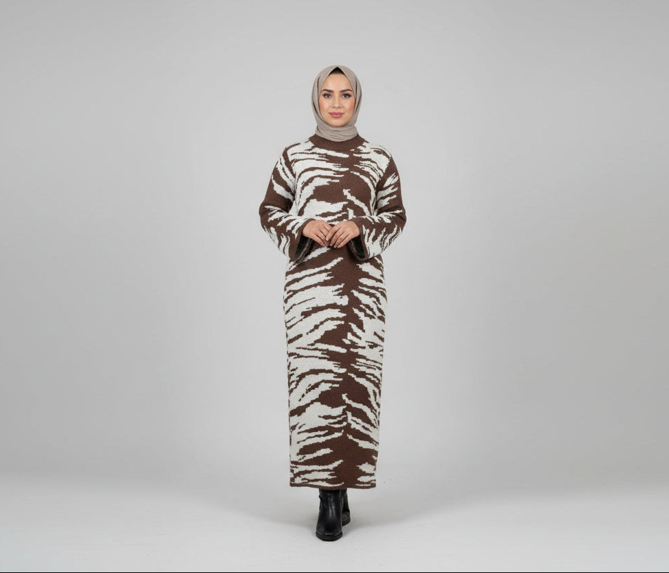 Person wearing a zebra print outfit taking a mirror selfie in a room.